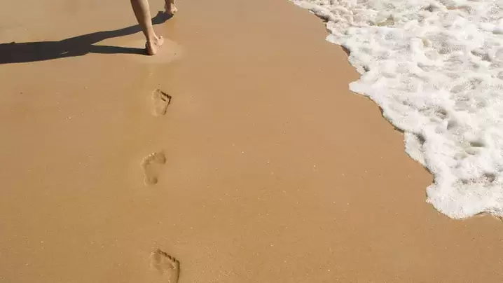 footprints on the sandy shore